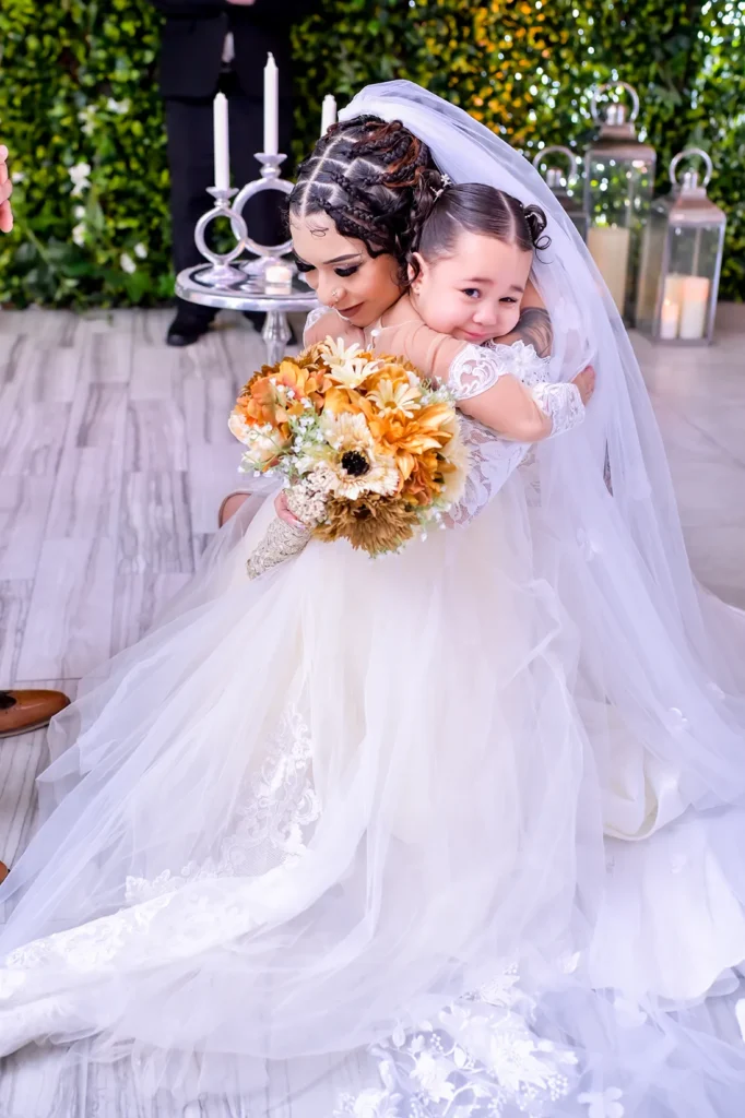 bride embracing daughter at the alter for a heartfelt moment