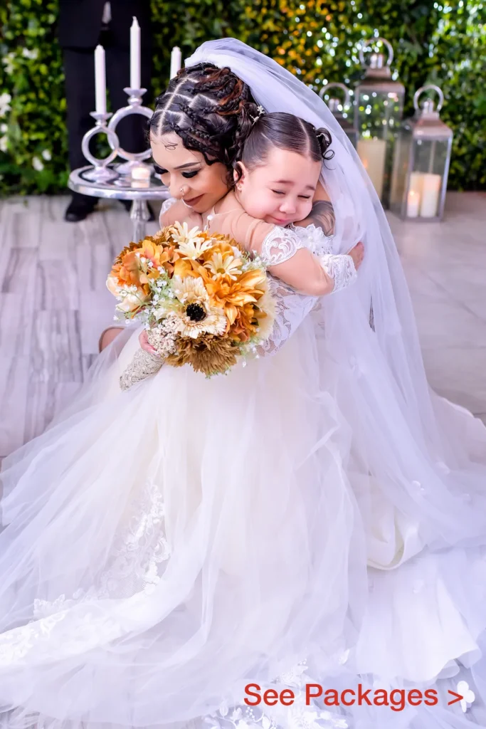 Bride hugging her young daughter at the alter