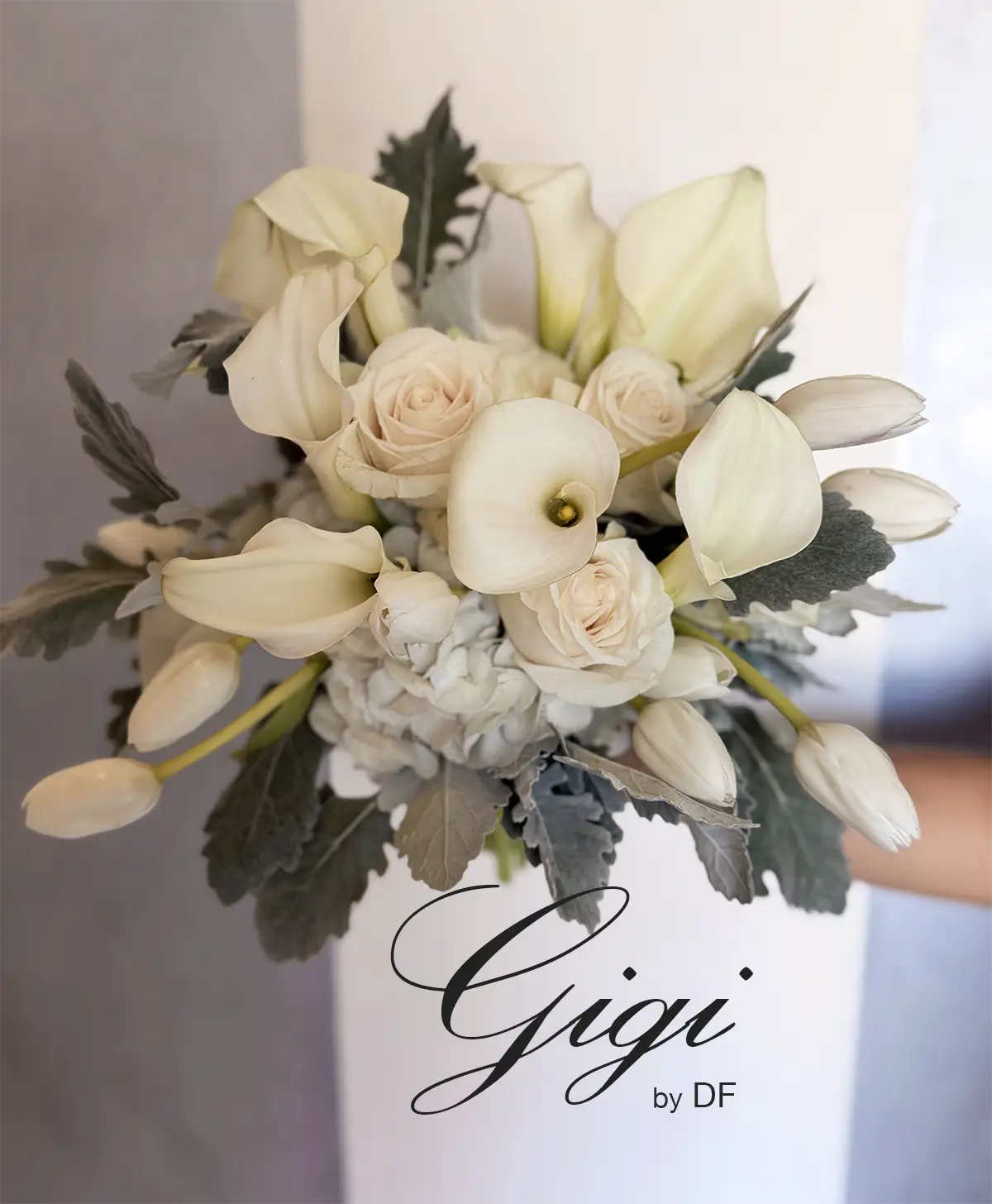 A chic floral bouquet named Gigi designed by Project Runway alumni Daniel Franco for Albertson Wedding Chapel made of white tulips, Cala lilies, white roses, hydrangea and dusty miller leaves.